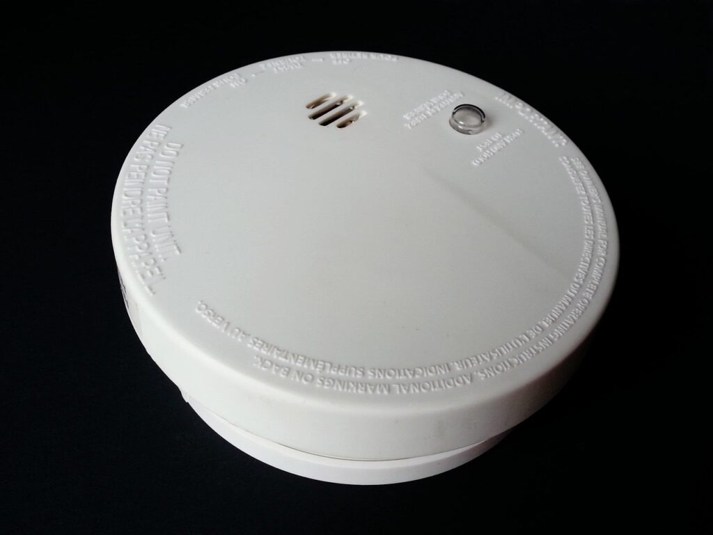 Fire and smoke sensor and alarm buzzer integrated into security alarm systems in Kerala for emergency detection and alerting