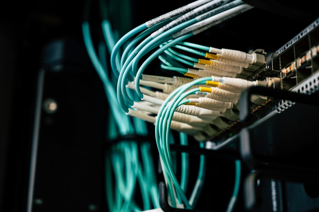 Close-up of network cables connected to a switch, showcasing professional network installation services in Kerala