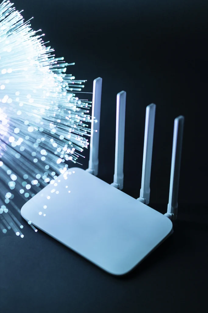 A modern wireless router emitting bright light streaks representing network signals, illustrating advanced network installation services in Kerala.